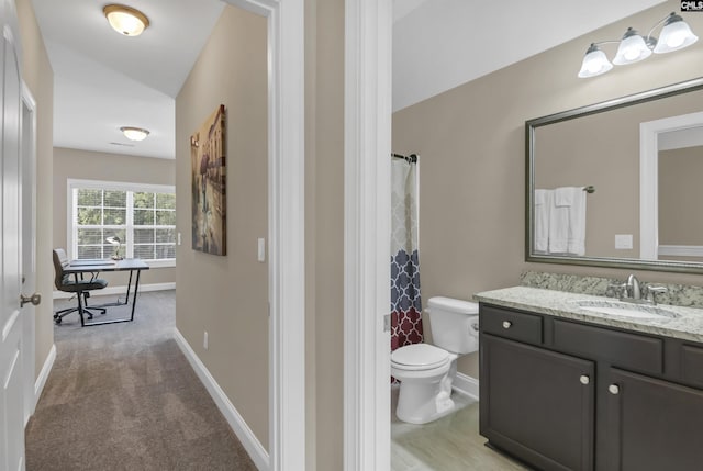 bathroom with vanity, toilet, and walk in shower