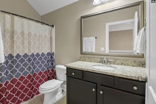 bathroom featuring vanity, lofted ceiling, and toilet