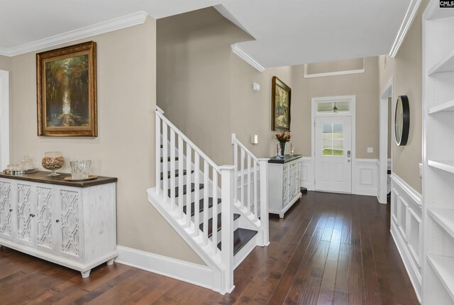 entrance foyer featuring dark wood-type flooring and ornamental molding