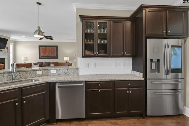 kitchen with ceiling fan, sink, dark brown cabinetry, and stainless steel appliances