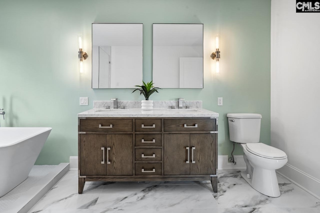 bathroom with a bathing tub, vanity, and toilet