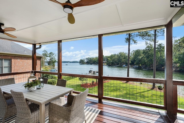 sunroom featuring ceiling fan, a healthy amount of sunlight, and a water view