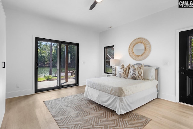 bedroom featuring access to outside, ceiling fan, and light hardwood / wood-style flooring