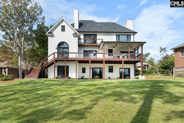 back of house with a yard, a deck, and ceiling fan