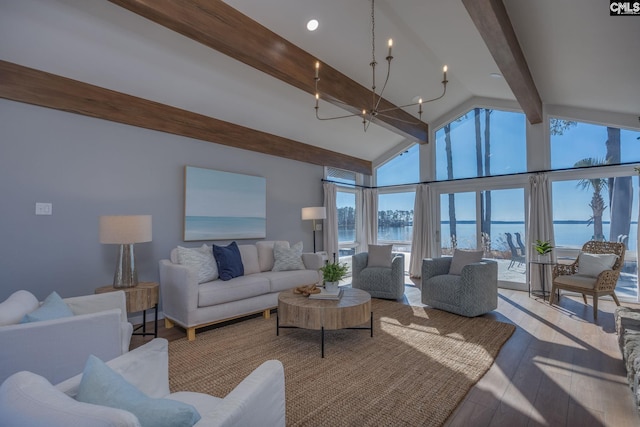 living room with vaulted ceiling with beams, light hardwood / wood-style floors, and a water view