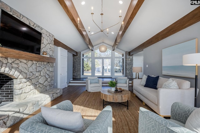 living room featuring lofted ceiling with beams, dark hardwood / wood-style flooring, a fireplace, and an inviting chandelier