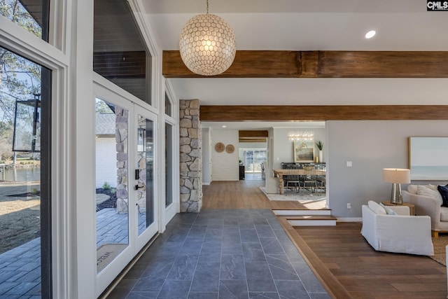 hall featuring beam ceiling, dark hardwood / wood-style floors, and an inviting chandelier