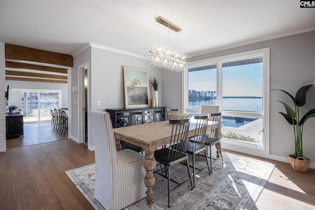 dining area featuring beam ceiling, a notable chandelier, crown molding, a water view, and hardwood / wood-style flooring