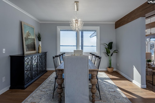 dining space with a notable chandelier, wood-type flooring, and ornamental molding