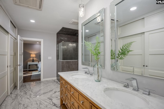 bathroom with vanity and a shower with door