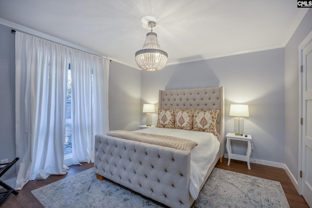 bedroom with a notable chandelier, dark hardwood / wood-style floors, and crown molding