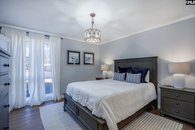 bedroom featuring a notable chandelier, dark hardwood / wood-style floors, and crown molding