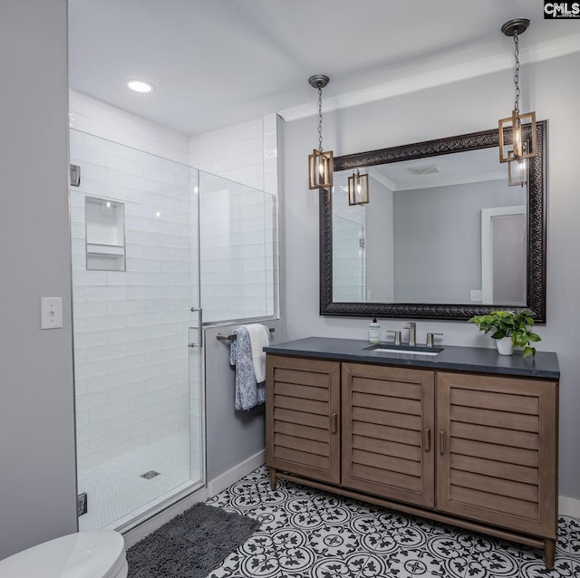 bathroom with tile patterned floors, a shower with door, vanity, and toilet