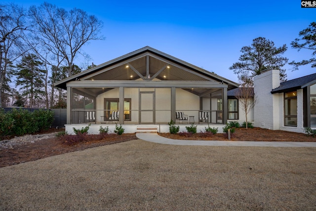 view of front of home featuring a sunroom