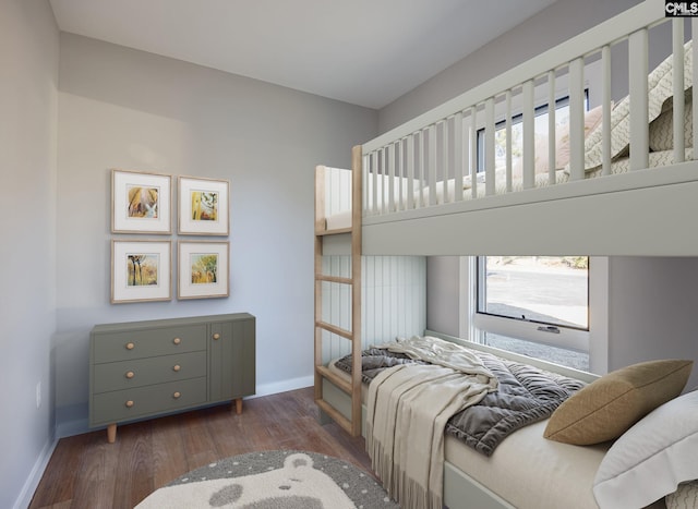 bedroom with dark hardwood / wood-style flooring