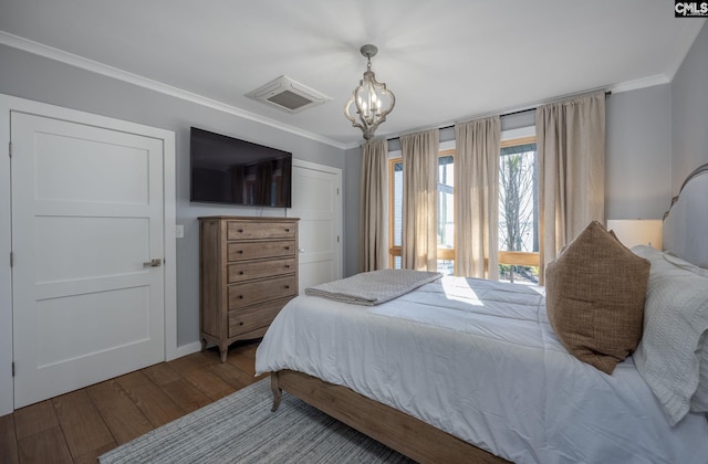 bedroom with a chandelier, crown molding, and wood-type flooring