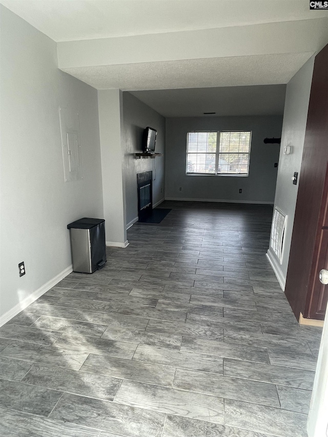 unfurnished living room featuring electric panel