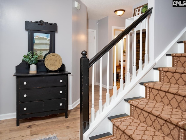 stairway featuring hardwood / wood-style flooring