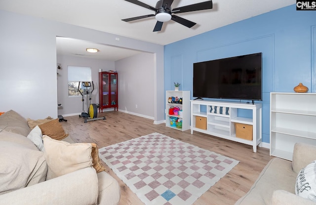 living room with ceiling fan and light hardwood / wood-style floors