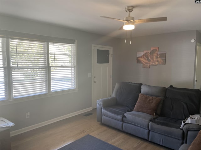 living room with hardwood / wood-style flooring and ceiling fan