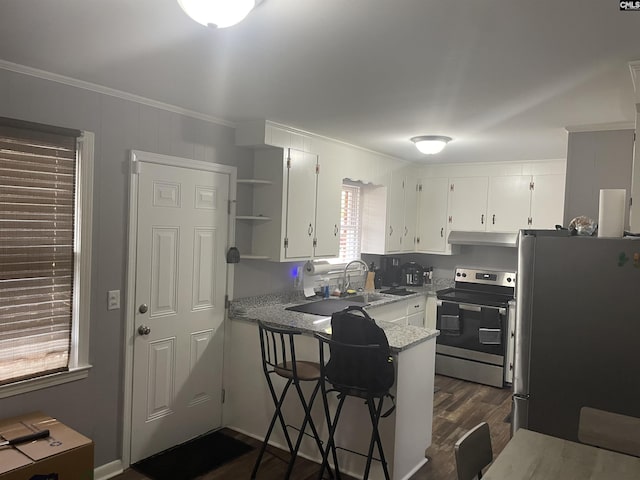 kitchen featuring light stone countertops, stainless steel appliances, dark wood-type flooring, crown molding, and white cabinetry