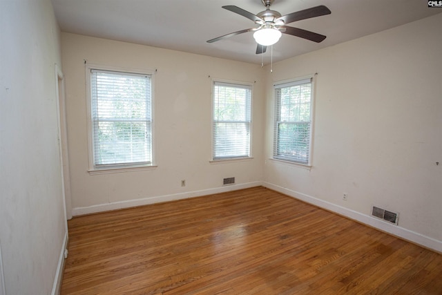 spare room featuring hardwood / wood-style floors and ceiling fan