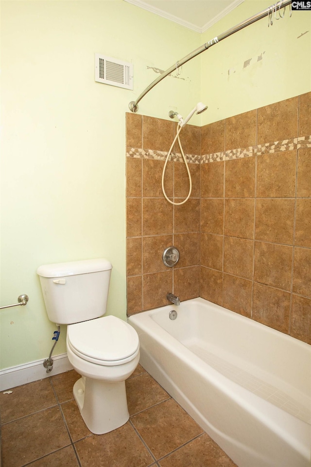 bathroom with tile patterned flooring, tiled shower / bath combo, toilet, and crown molding