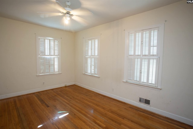 spare room featuring hardwood / wood-style floors and ceiling fan