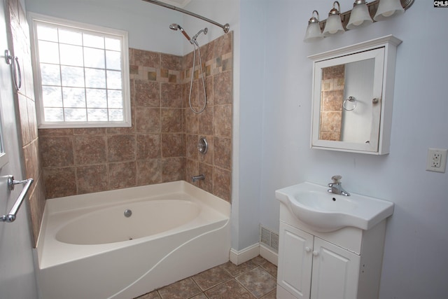 bathroom with vanity, tile patterned floors, and tiled shower / bath combo