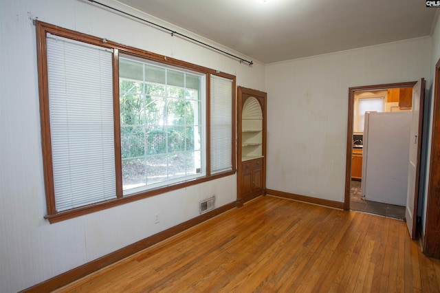 spare room featuring wood-type flooring