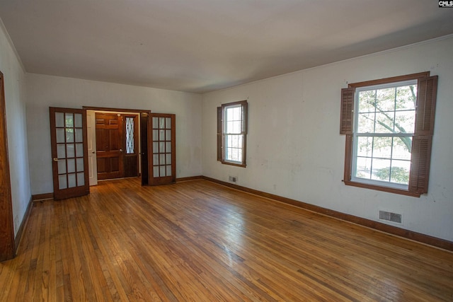 spare room with french doors and dark wood-type flooring