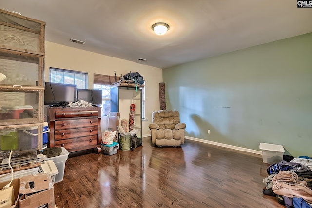 sitting room featuring dark wood-type flooring