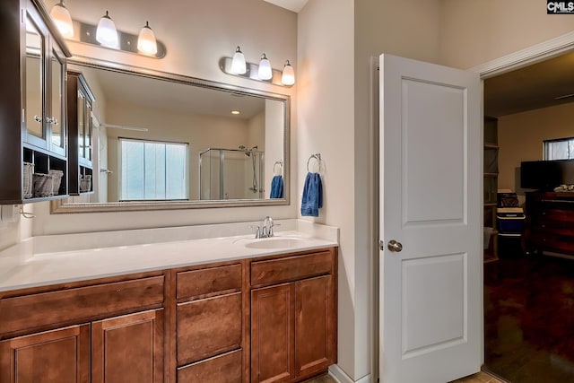 bathroom with a shower with door and vanity