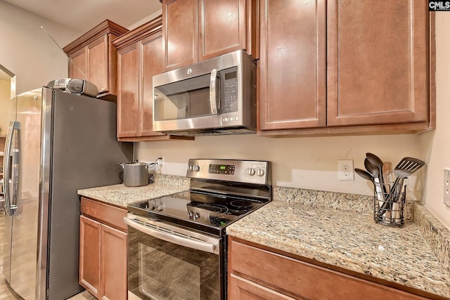 kitchen with light stone counters and stainless steel appliances