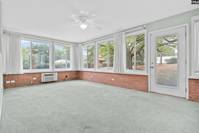 unfurnished sunroom featuring a wall mounted AC and ceiling fan