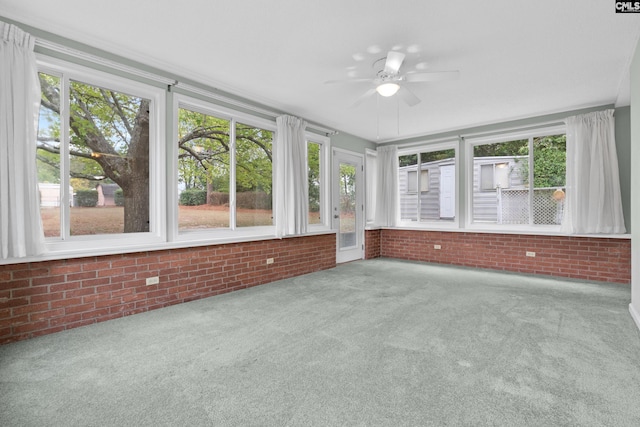 unfurnished sunroom featuring ceiling fan