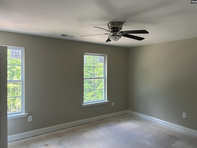 unfurnished room featuring plenty of natural light and ceiling fan