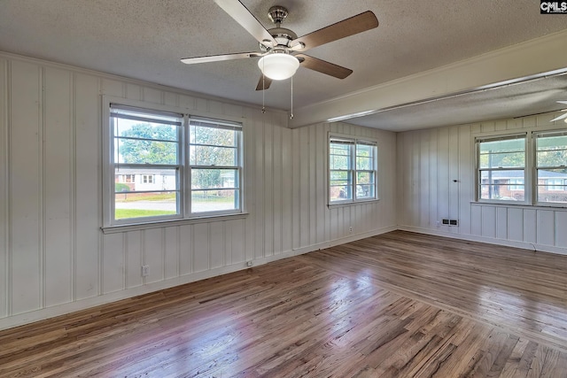 unfurnished room featuring ceiling fan, a textured ceiling, and light hardwood / wood-style flooring