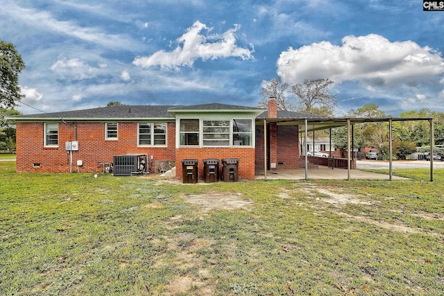 back of property featuring a patio, a lawn, and central air condition unit