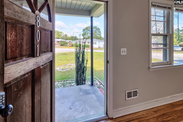 doorway to outside featuring hardwood / wood-style flooring and plenty of natural light