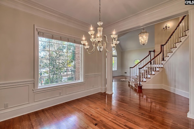 unfurnished dining area with hardwood / wood-style flooring, a notable chandelier, a healthy amount of sunlight, and crown molding