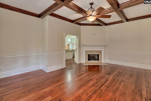 unfurnished living room with hardwood / wood-style floors, coffered ceiling, ceiling fan, a premium fireplace, and beamed ceiling