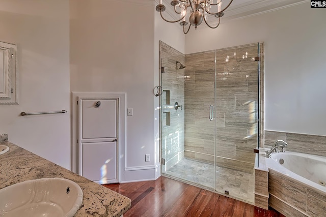 bathroom featuring vanity, crown molding, independent shower and bath, a notable chandelier, and hardwood / wood-style floors