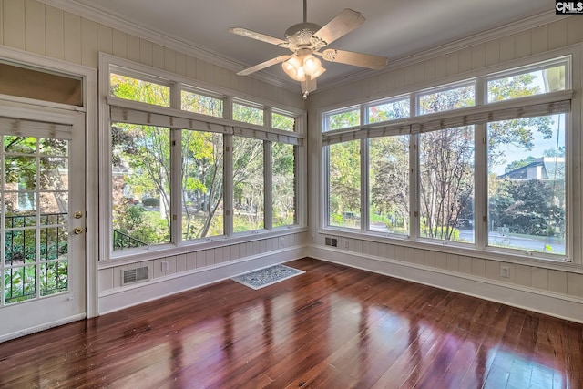 unfurnished sunroom with ceiling fan and a wealth of natural light