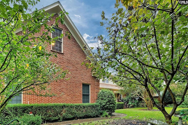 view of side of home with a lawn