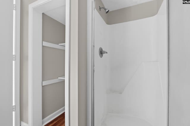 bathroom featuring a shower and wood-type flooring