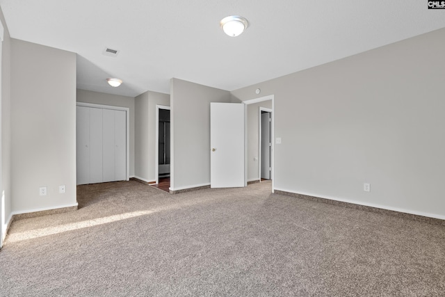 unfurnished room featuring dark colored carpet