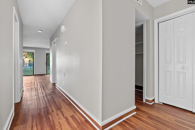 corridor with wood-type flooring