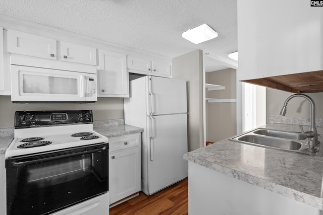 kitchen with sink, dark wood-type flooring, a textured ceiling, white appliances, and white cabinets