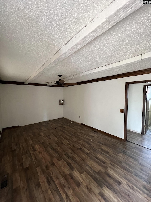 spare room featuring dark hardwood / wood-style floors, ceiling fan, and a textured ceiling